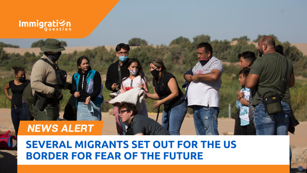 A group of migrants, including adults and children, interact with a border patrol officer at the US border, with the Immigration Question logo and a news alert banner stating 'Several Migrants Set Out for the US Border for Fear of the Future